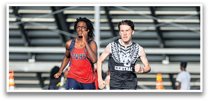 Two runners on a track. Description generated by AI
