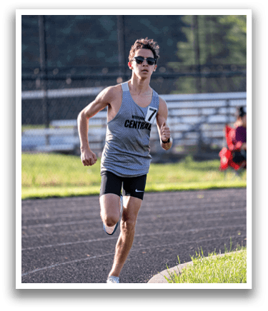 A man running on a track. Description generated by AI