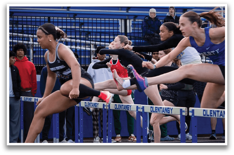 A blue and white track field with a blue and white hurdle. Description generated by AI