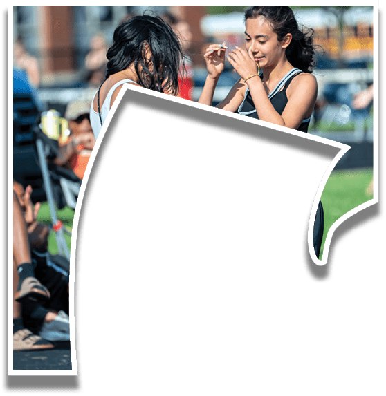 Two women talking to each other. Description generated by AI