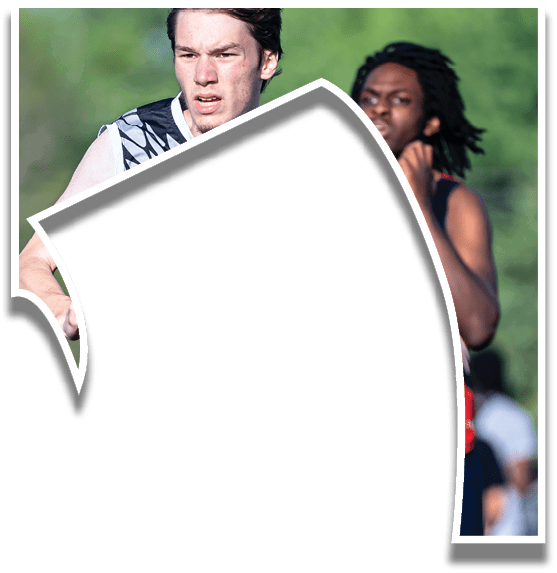 A man running on a track with a red shirt and a woman running behind him. Description generated by AI