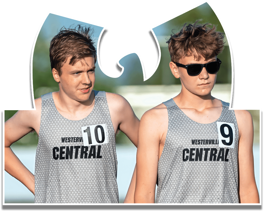 Two boys wearing grey shirts and black shorts. Description generated by AI
