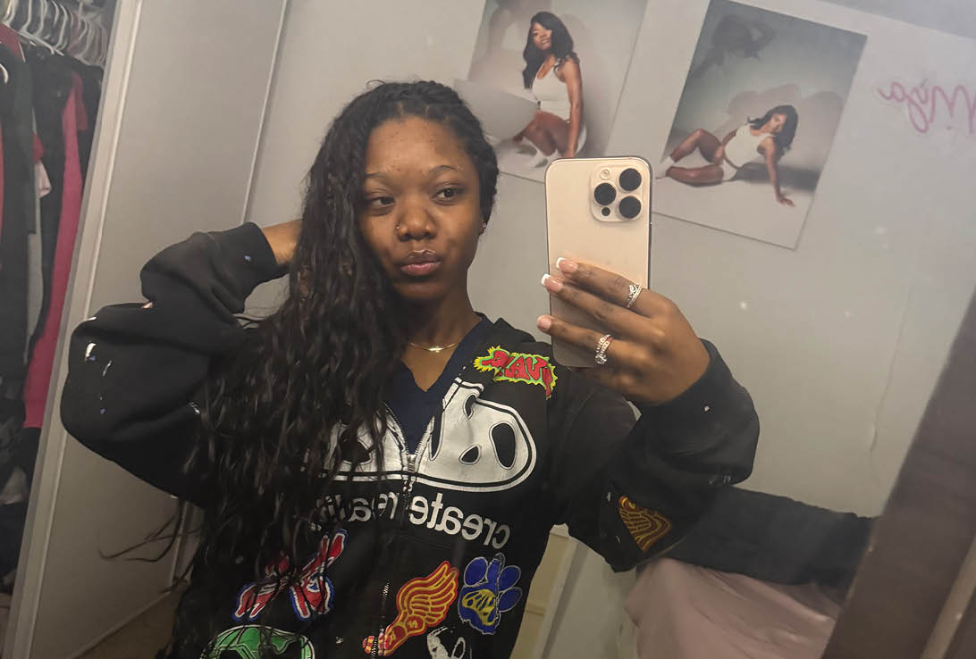A woman taking a selfie in a mirror. Description generated by AI