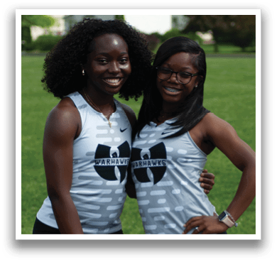 Two women wearing gray and white shirts. Description generated by AI