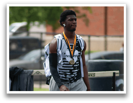 A man wearing a black and white shirt and a gold medal. Description generated by AI
