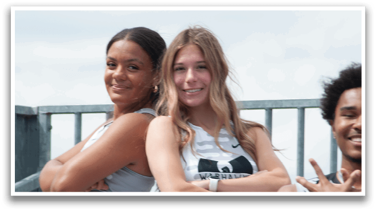 Two women standing next to each other. Description generated by AI