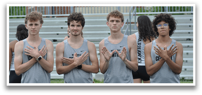 Four men wearing gray and black shorts and shirts. Description generated by AI