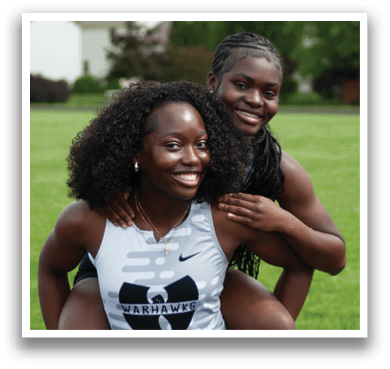 Two girls wearing black and white shirts. Description generated by AI