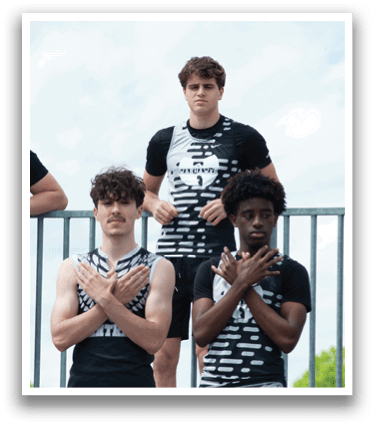 Three men standing on a fence. Description generated by AI