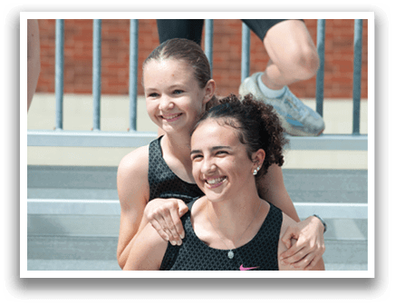 Two girls wearing black and white shirts. Description generated by AI
