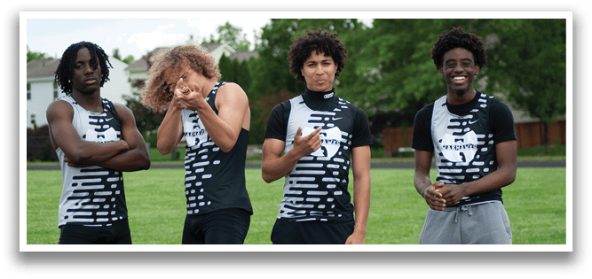 Four young men wearing black and white shirts and shorts. Description generated by AI