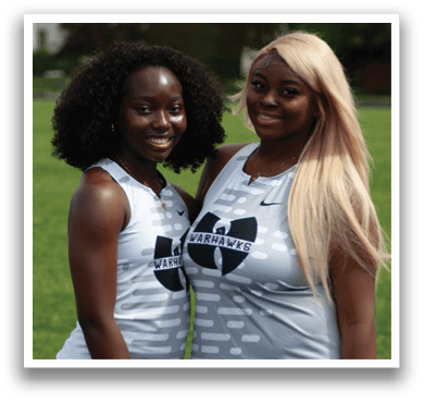 Two women wearing black shorts and white shirts. Description generated by AI