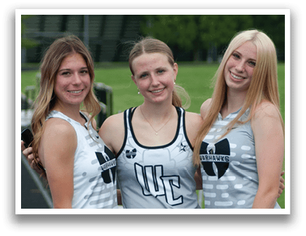 Three women wearing grey and black uniforms. Description generated by AI