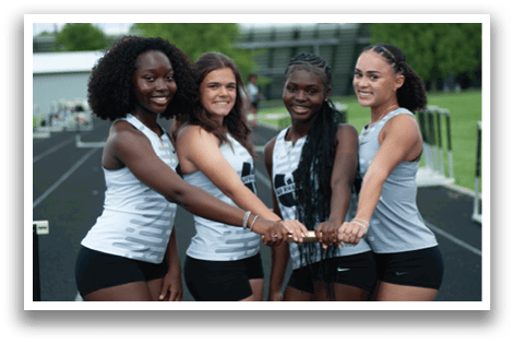 Four women wearing black and white uniforms. Description generated by AI