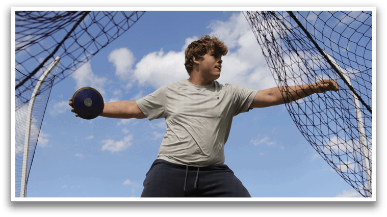 A man is swinging a baseball bat in a field. Description generated by AI