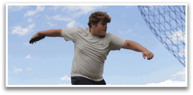 A man is standing in a grassy field. Description generated by AI
