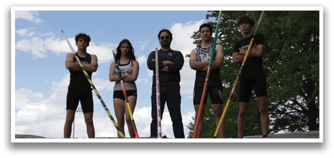 Four people standing on a platform with poles. Description generated by AI