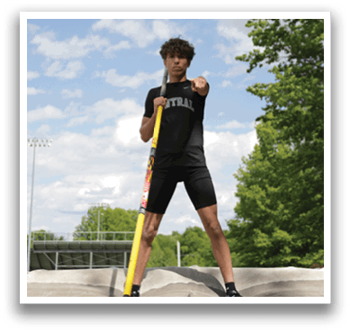 A man is standing on a skateboard ramp. Description generated by AI