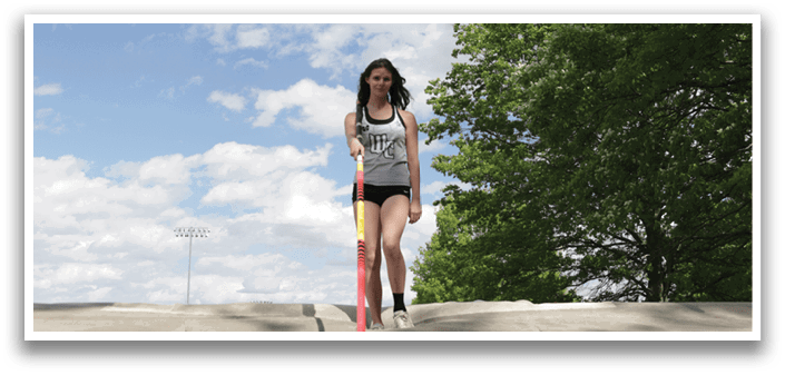 A woman standing on a pole. Description generated by AI