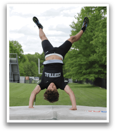 A man is doing a handstand on a trampoline. Description generated by AI