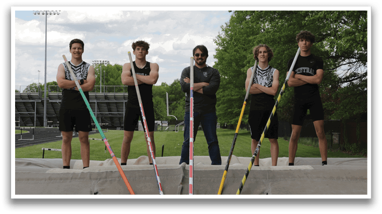 A group of men standing in front of a ramp. Description generated by AI