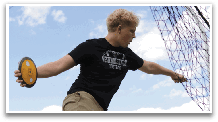 A man in a black shirt and tan pants is throwing a frisbee. Description generated by AI