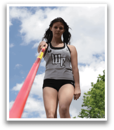 A woman is standing on a red pole. Description generated by AI