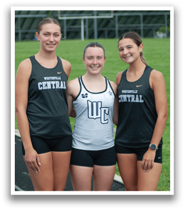 Three women wearing black and grey uniforms. Description generated by AI