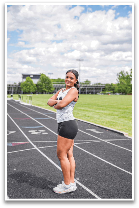 A woman standing on a track. Description generated by AI