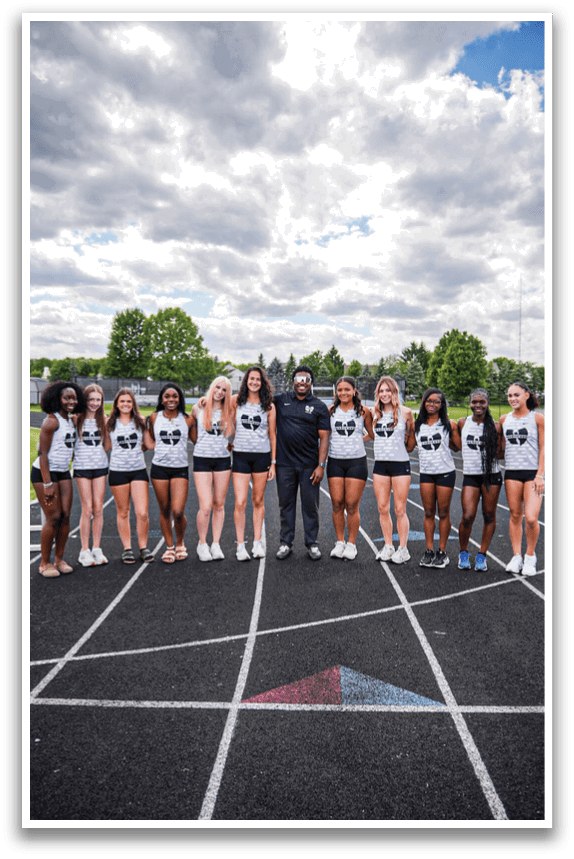 A group of girls wearing black and white uniforms. Description generated by AI