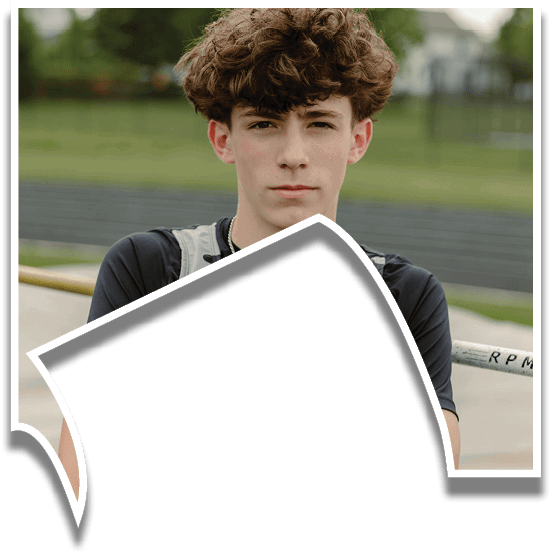 A young man wearing a black and white shirt with his arms crossed. Description generated by AI