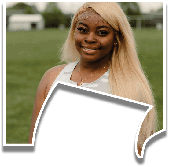 A woman wearing a grey and black shirt with the word Warhawk on it. Description generated by AI