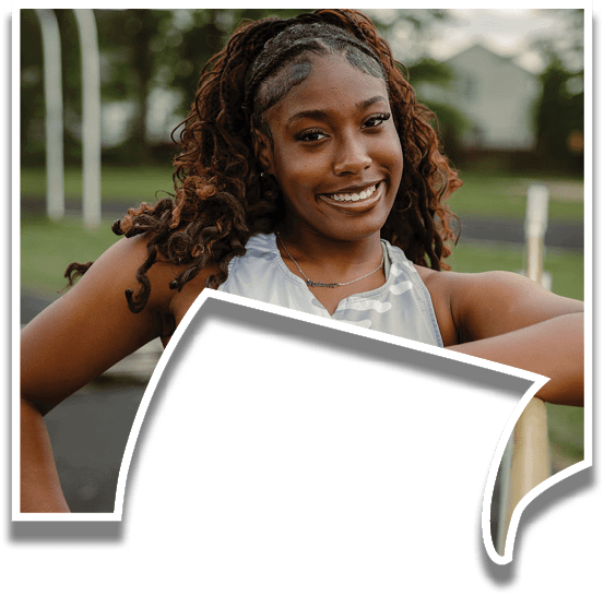 A woman wearing a grey and white shirt with a black and white pattern. Description generated by AI