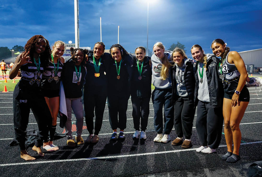 A group of girls wearing medals. Description generated by AI