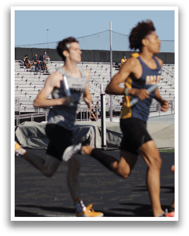 A man running on a track. Description generated by AI