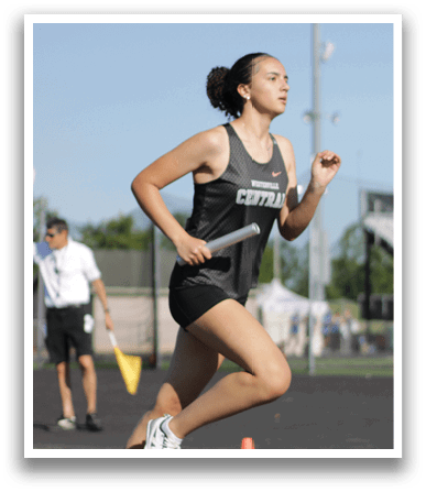 A woman running on a track. Description generated by AI