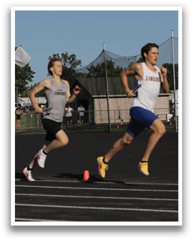 Two runners on a track. Description generated by AI
