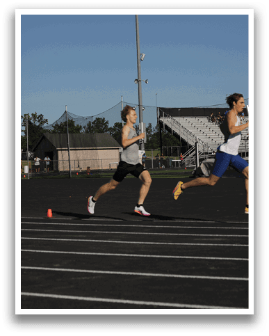 Two runners on a track. Description generated by AI