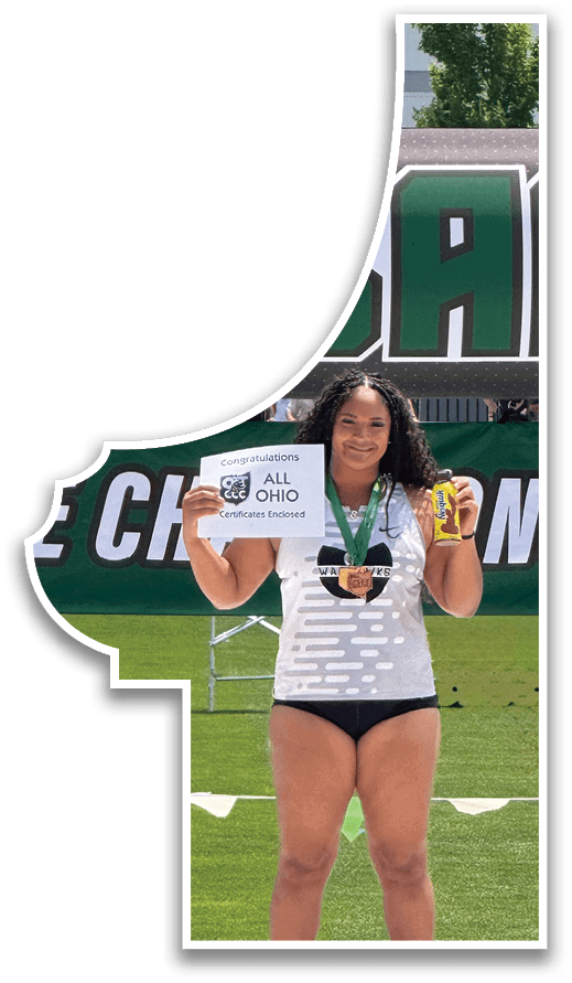 A woman standing on a podium with a sign that says DHSA. Description generated by AI