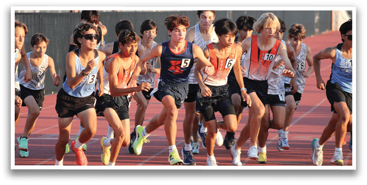 A group of young boys running on a track. Description generated by AI