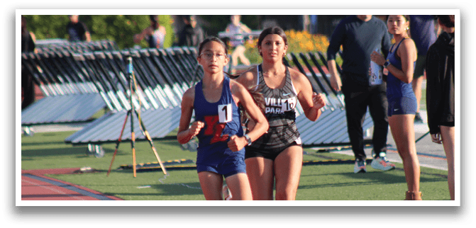 A girl running on a track. Description generated by AI
