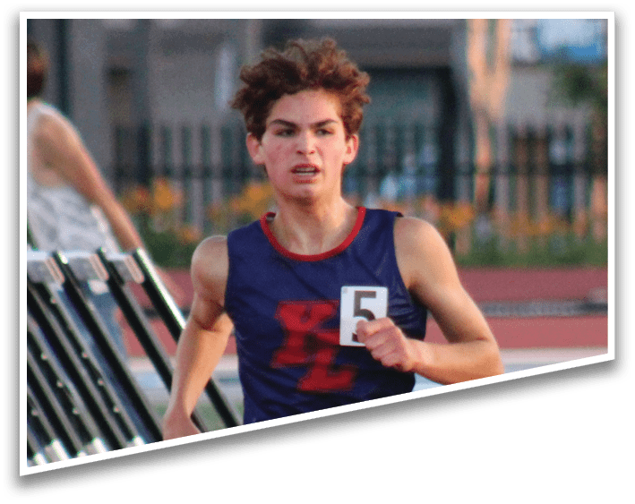 A man running on a track with a number on his shirt. Description generated by AI