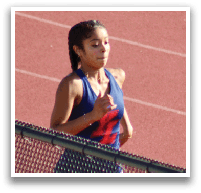 A woman running on a track. Description generated by AI
