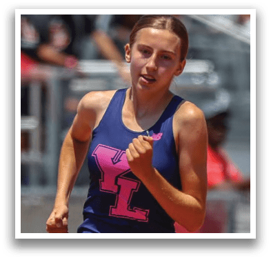 A woman running in a blue and purple tank top. Description generated by AI