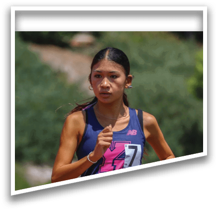 A woman running on a track. Description generated by AI