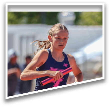A girl running with a pink and blue shirt. Description generated by AI