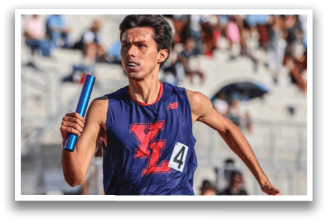 A man wearing a blue and red shirt is running. Description generated by AI