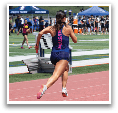 A woman running on a track. Description generated by AI