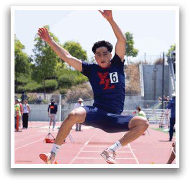 A man is jumping in the air on a track. Description generated by AI