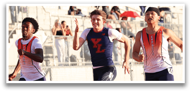 Two men are running on a track, one wearing a blue shirt and the other wearing a white shirt. They are both wearing shorts. The men are running in front of a crowd of people who are watching them. AI generated content